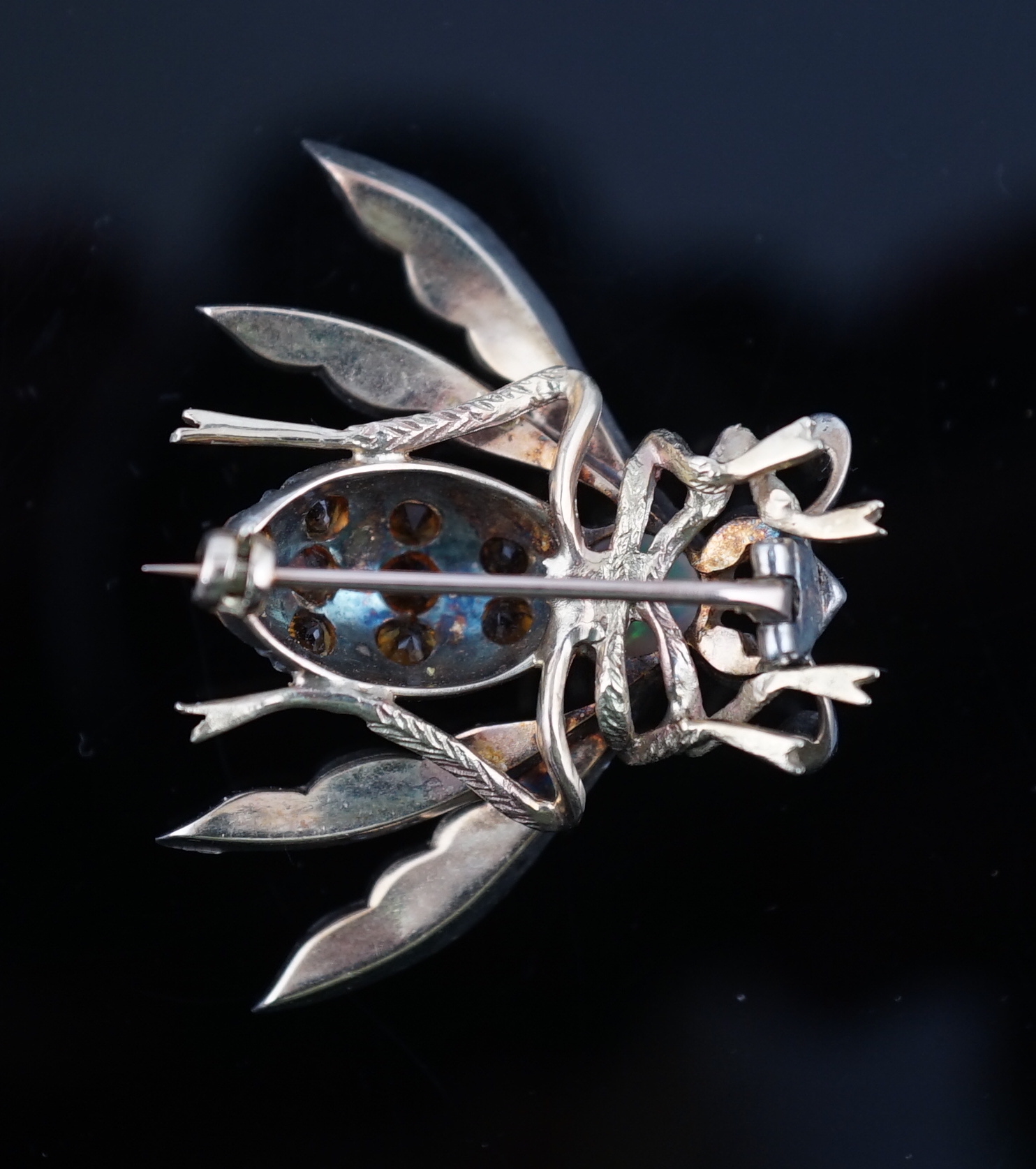 A late Victorian gold and silver, white opal, ruby and citrine? cluster set bug brooch